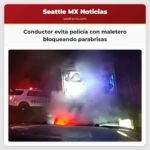 Conductor evita policía con maletero bloqueando parabrisas