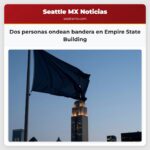 Dos personas ondean bandera en Empire State Building